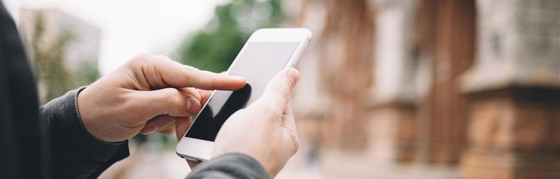 Closeup_Of_Hands_And_Mobile_Phone