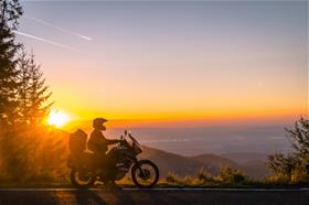 Motorcylist_Stopped_On_Side_Of_Highway_To_View_Sunset